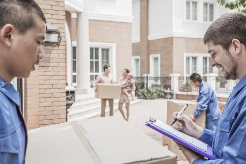 House movers helping a family move in a Fulham residential street