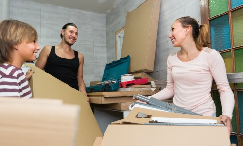 Moving boxes and furniture being loaded during a Fulham removals job