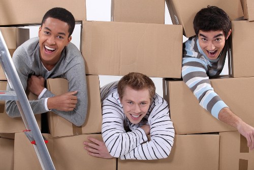 Loaders packing furniture and boxes into a moving truck in Fulham