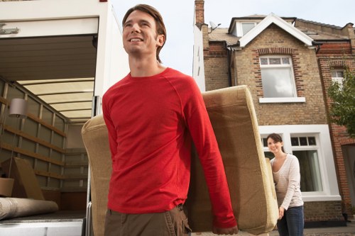 Packed moving boxes and furniture ready for a house move in Fulham